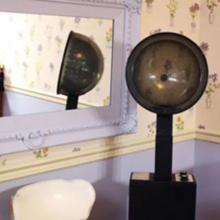 A vintage lamp reflected in a wall mirror, adding a classic touch to the room decor.
