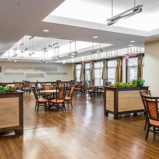 Spacious and well-lit dining area with elegant furnishings.