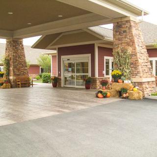 A building entrance with stone pillars and seasonal decorations.