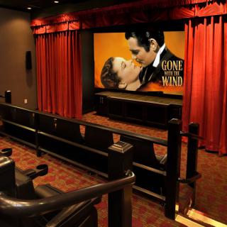 Interior of a movie theater featuring a screening of 'Gone with the Wind'.