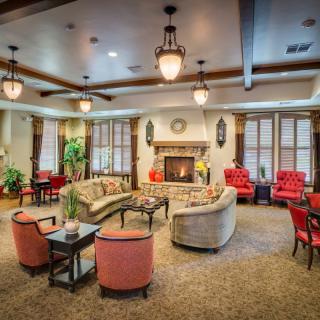 A spacious and cozy living room with modern furniture and a fireplace.