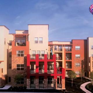 A modern apartment building with vibrant colors and balconies.