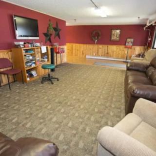 A cozy living room with comfortable seating, a television, and warm decor.