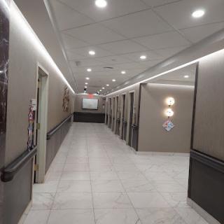 A modern hallway featuring sleek lighting and neutral-toned walls.