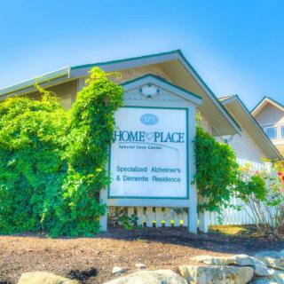 A sign for a residential apartment complex, surrounded by lush greenery.