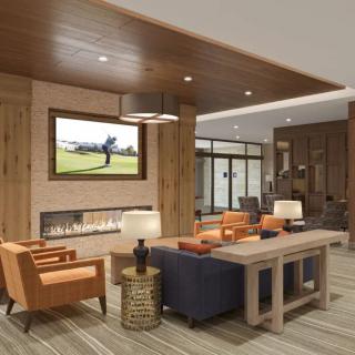 A modern living room with comfortable seating and wooden accents.