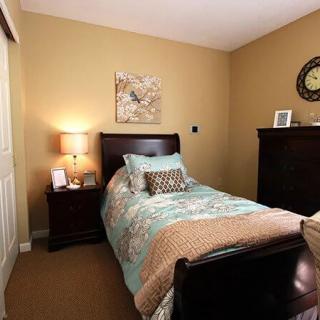 A cozy bedroom with a single bed and warm decor.