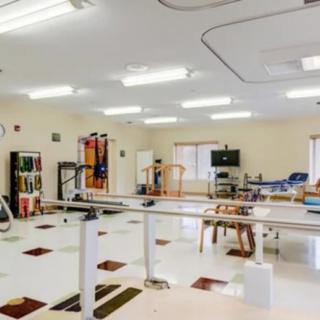 A rehabilitation therapy room with various exercise equipment.
