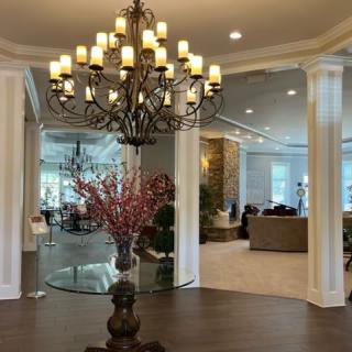 A luxurious lobby featuring a grand chandelier and elegant seating area.