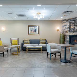 A cozy lobby area featuring comfortable seating and a warm fireplace.