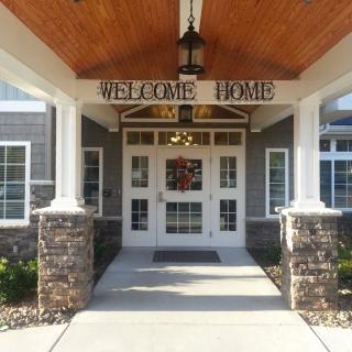A welcoming entrance with a 'Welcome Home' sign.