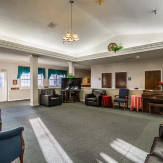 A spacious living room with comfortable seating and a television.