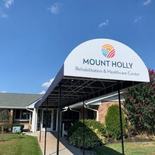 Entrance to the Mount Holly Rehabilitation & Healthcare Center on a clear day.