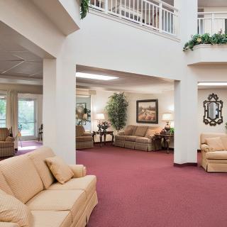 A spacious lobby area featuring comfortable sofas, artwork, and decorative elements.