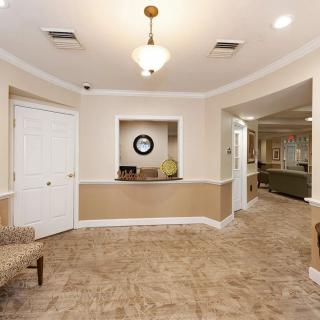A well-lit reception area with tiled flooring and comfortable seating.
