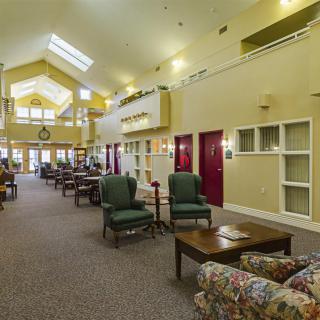 A spacious lobby with comfortable seating and warm lighting.
