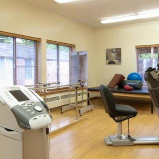 A physical therapy room equipped with rehabilitation tools and exercise equipment.