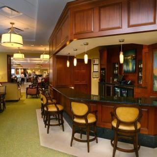 A cozy bar area with wooden paneling and comfortable seating.