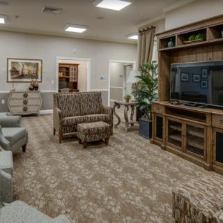 A cozy living room featuring a large television, comfortable seating, and stylish decor.