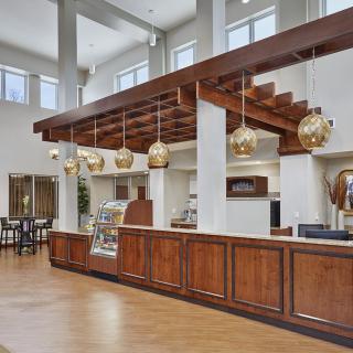 A modern coffee shop interior with wooden accents and stylish lighting fixtures.