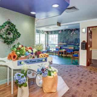 A bright and colorful children's playroom with floral decorations and seating.