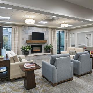A modern living room with comfortable seating, a fireplace, and a television.