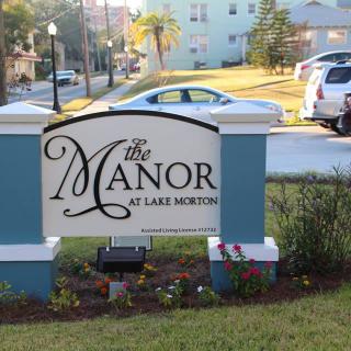 Sign for The Manor at Lake Morton located outdoors near a residential area.