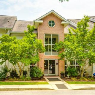 A suburban residential building surrounded by greenery.