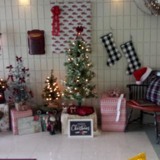 A charming holiday corner decorated for Christmas with twinkling lights, a festive tree, and wrapped gifts.