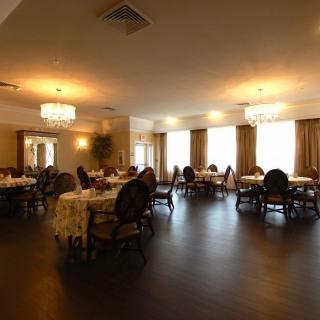 An elegant dining room with neatly arranged tables and soft lighting.