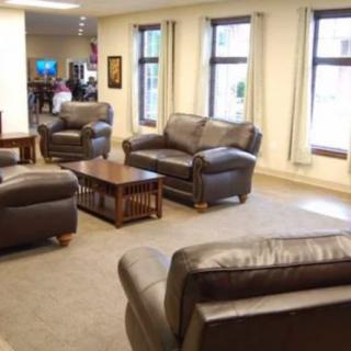 A cozy living room with leather sofas and a coffee table.