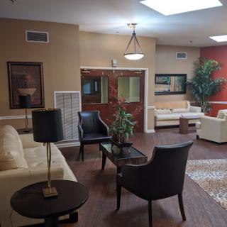 A cozy and modern lobby area with comfortable seating and decorative plants.