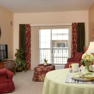 A cozy living room with warm colors, featuring a sofa, television, and decorative accents.