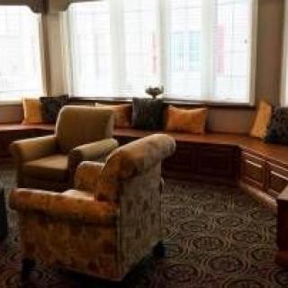 Cozy living room with armchairs and window seating.