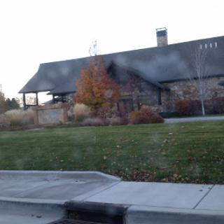 A beautiful stone house surrounded by well-maintained landscaping.