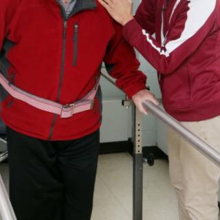 A person receiving support during a physical therapy session.