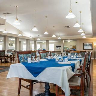A well-arranged dining area with neatly set tables and modern lighting.