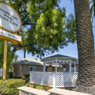 A picturesque gazebo surrounded by lush greenery and a prominent sign.