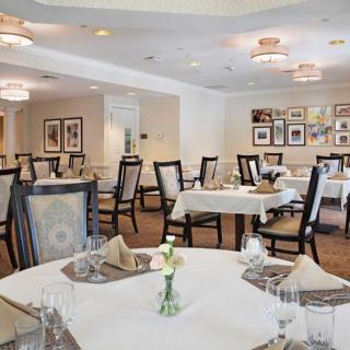 An elegant dining room with neatly arranged tables and chairs, ready for guests.