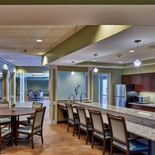 A modern kitchen and dining area with sleek countertops and comfortable seating.
