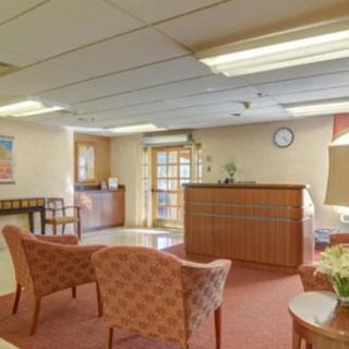 A cozy waiting room with armchairs and a reception desk.