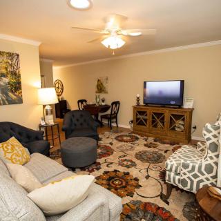 A cozy living room with comfortable furniture and a television.