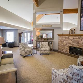 A cozy living room with modern decor, featuring comfortable seating and a fireplace.