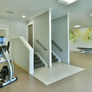A modern gym interior featuring exercise stairs and fitness equipment.