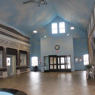 Spacious lobby area of a community center with blue walls and ample natural light.