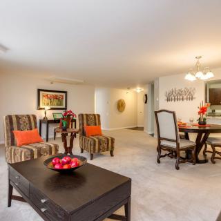 A spacious living and dining area with elegant furnishings and decor.