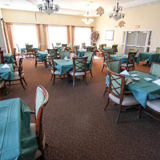 An empty dining room with neatly arranged tables and chairs.