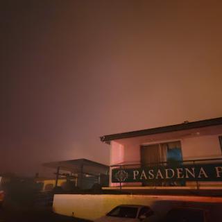 A foggy night view of a building in Pasadena, shrouded in atmospheric haze.