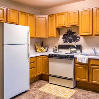 A cozy kitchen with wooden cabinets and standard appliances.