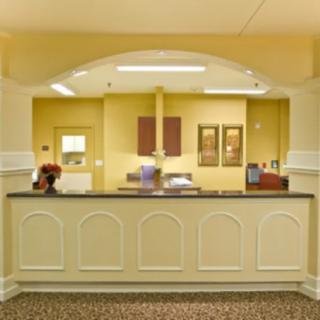 A well-organized reception desk in an office setting, featuring decorative elements and a warm color palette.